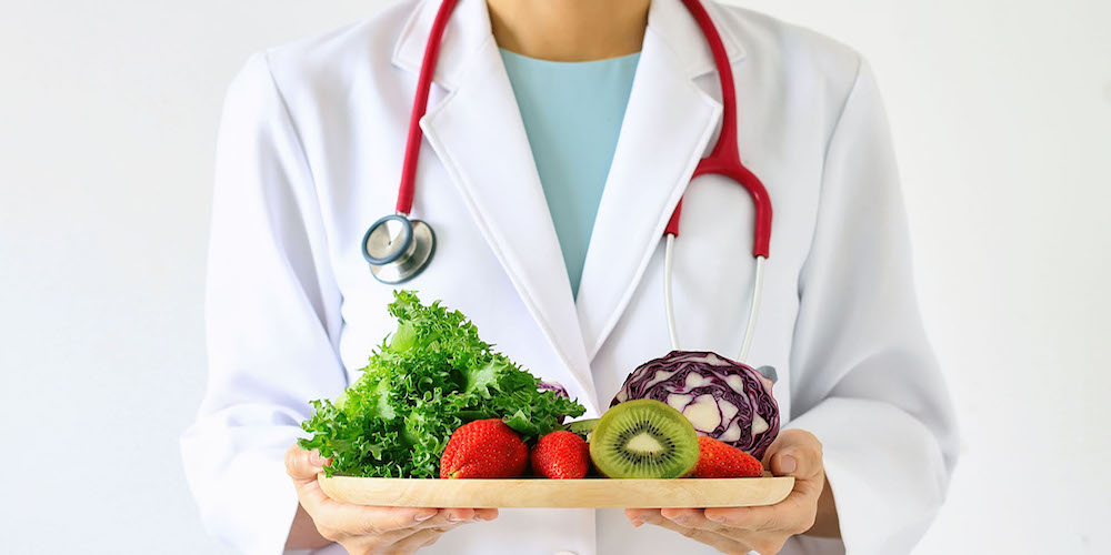 Doctor holding fresh fruit and vegetable, Healthy diet, Nutrition food as a prescription for good health.